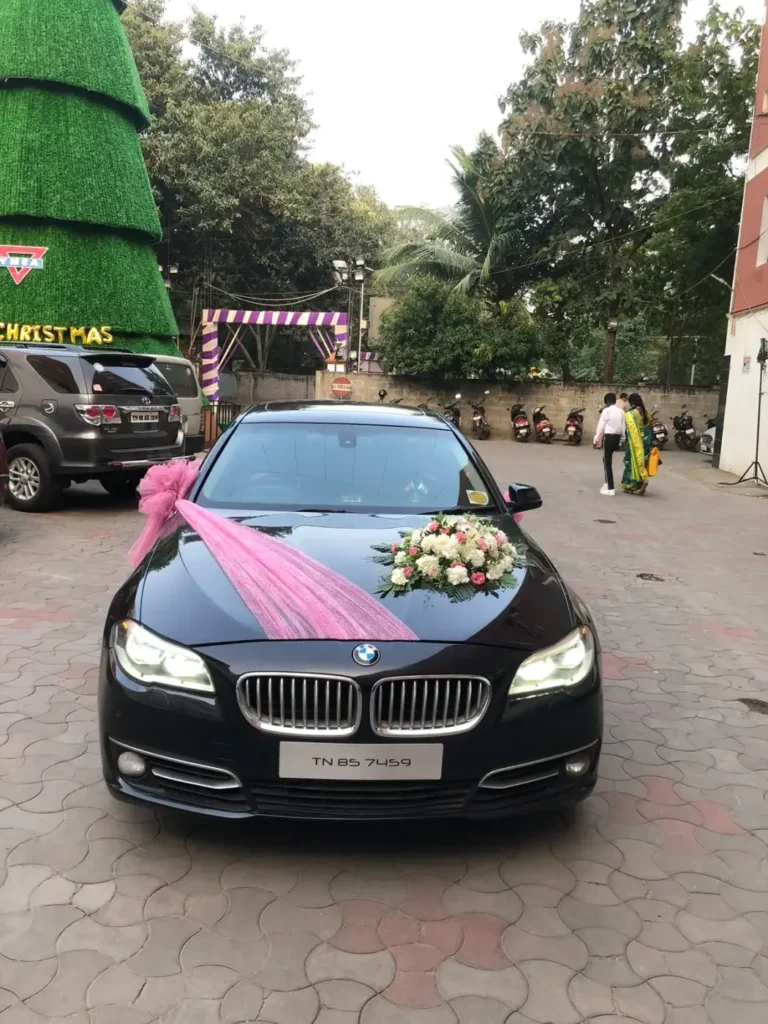 Black BMW 5 Series with wedding flower decoration, Chennai